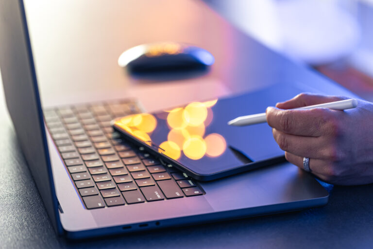 close-up-business-hand-with-stylus-pen-working-digital-tablet-laptop